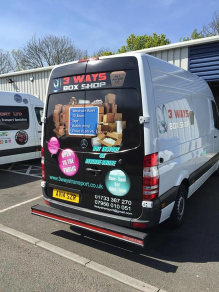Picture Rear view of wrapped van with rear doors covered with vinyl adhesive imagery of packaging materials